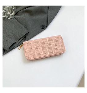 Pink woven texture long zipper wallet for women shown in a stylish lifestyle setting