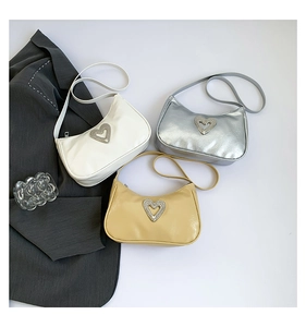 Three trendy hobo bags in white, silver, and beige with heart rhinestone ornaments