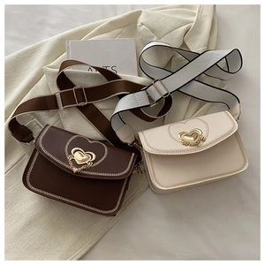 Detail of vintage square bags with golden heart-shaped metal locks and woven edges