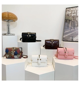 Chic mini square handbags in diverse colors displayed on geometric pedestals