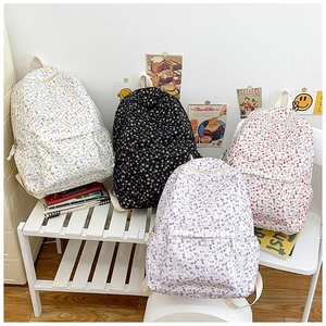 Detail of floral canvas backpacks showing multiple colors and multiple storage compartments