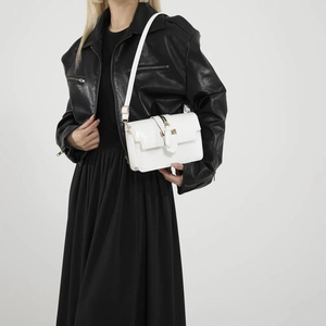 Minimalist white rectangular crossbody bag with elegant gold metal buckle and leather strap