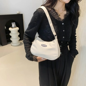 Chic beige nylon hobo bag for women with wide adjustable strap and minimalist aesthetic