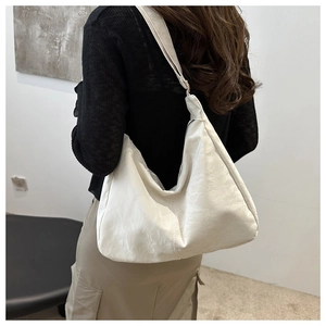 Detail view of the cream pleated tote bag showing large capacity and soft texture