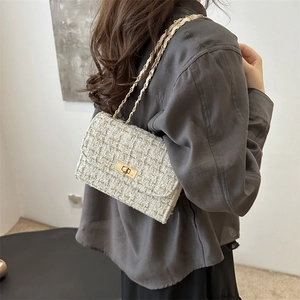 Elegant off-white tweed shoulder bag with gold chain strap and metallic rotary buckle