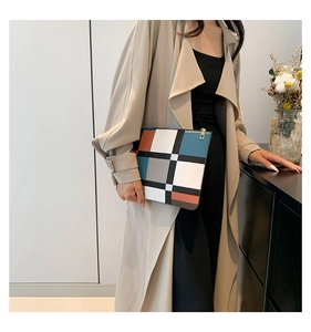 Close-up of stylish clutch featuring Mondrian-style geometric color block pattern