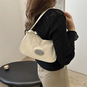 Chic cream crescent shoulder bag with silver metal plaque and sleek minimalist design