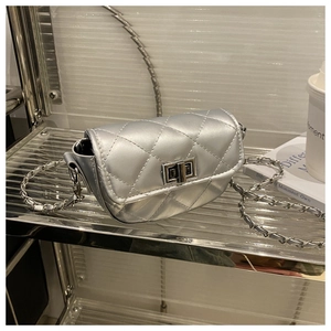 Close-up of a silver quilted mini bag with a metallic clasp and chain shoulder strap