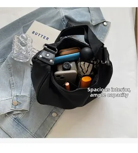 Top-down view of black nylon bag showing large interior capacity for umbrella and phone