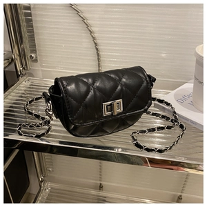 Detail of black quilted leather saddle bag with silver chain strap and metal turn lock