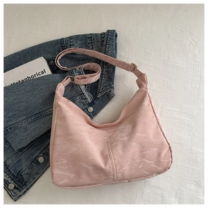 Detail of light pink marble pattern tote bag with metal zipper and wide strap