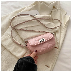 Detail of pink quilted mini crossbody bag with silver twist lock and chain strap