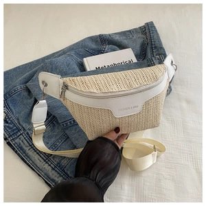 Close-up of woven straw fanny pack texture with white leather trim and fashion lettering
