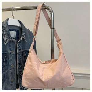 Pink minimalist tote bag with marble texture texture hanging on hanger with denim jacket