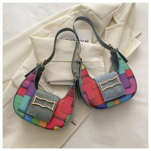 Detail of colorful woven rainbow hobo bags with metallic gold buckles on a blazer