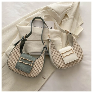 Detail of woven crescent hobo bags with unique wavy gold buckles and faux leather trim