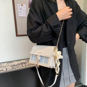 Fashionable cream white crossbody bag with blue tweed pattern and gold chain strap