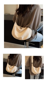 Detail view of cream-colored nylon crescent hobo bag showing side profile and silver buckle