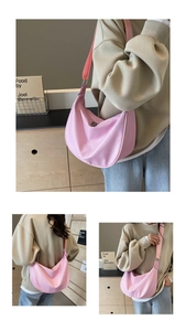 Pink nylon hobo bag with adjustable wide strap and zipper detail for versatile styling