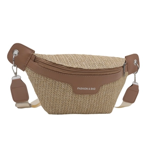 Handwoven straw chest bag with brown faux leather trim and adjustable shoulder strap