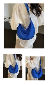 Detail of Klein blue nylon hobo bag with adjustable strap and silver zippers
