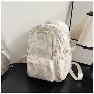 Detailed shot of beige nylon backpack with cute bear print and adjustable straps