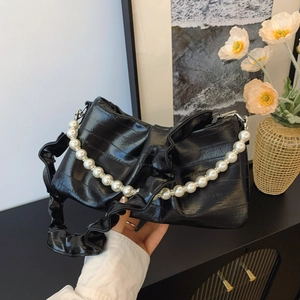 Elegant black pleated underarm bag with pearl chain and glossy patent leather finish