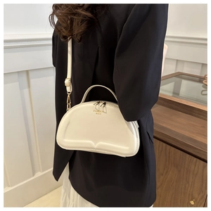 Modern white crescent crossbody bag with gold zipper and fashion bags lettering logo