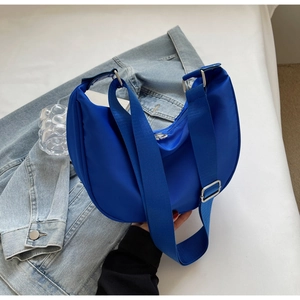 Close-up of Klein Blue nylon crescent bag showing high-quality fabric and silver buckle