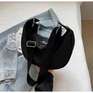 Close-up of a black nylon crescent bag with adjustable wide strap for daily wear