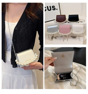 Detailed views of multi-color mini pearl chain crossbody bags with metal strap