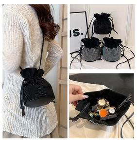 Detail view of rhinestone bucket bag interior capacity holding cosmetics and perfume