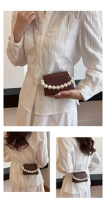 Detail of a dark brown leather mini flap bag with luxury pearl chain decoration