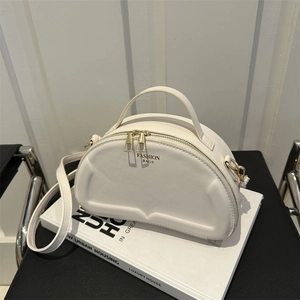 Minimalist cream white quilted shoulder bag with top handle and gold zipper hardware