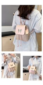 Detail of light pink PU leather backpack featuring butterfly buckle and versatile straps