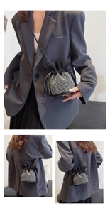 Detail view of sparkly black rhinestone bucket bag with drawstring closure and suede trim