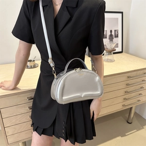 Silver quilted semi-circular handbag with shoulder strap and golden zipper detail