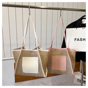 Detail of woven straw tote bags with leather pockets in pink and white trims