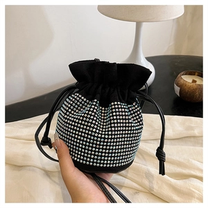 Detail of drawstring bucket bag with sparkling silver rhinestones on black faux suede