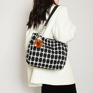 Classic black and white tweed tote bag with leather strap and plush monster charm