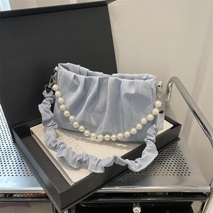 Light blue pleated cloud bag with pearl chain and matching wide strap on gift box