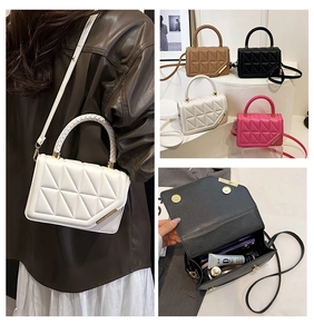 Detail of quilted small square bag with woven handle and interior storage view