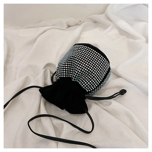 Close-up of drawstring closure and rhinestone details on luxury suede bucket bag