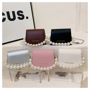 Detailed display of mini flap bags in five colors with pearl handles and metal chains