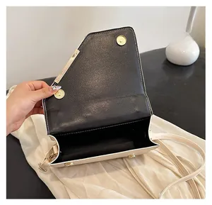 Interior view of contrast shoulder bag showing two golden magnetic closures and main compartment