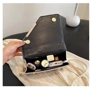 Detail showing internal storage capacity of the contrast stitching crossbody bag
