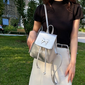 Silver mini backpack for women featuring a metallic PU finish and butterfly buckle detail
