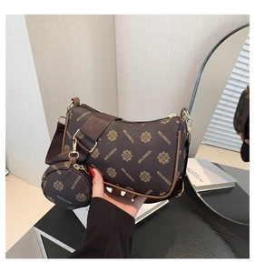 Detail of vintage patterned crossbody bag with wide strap and small round pouch