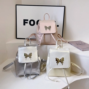 Three minimalist PU leather backpacks in pink, silver, and white with metal butterfly buckles