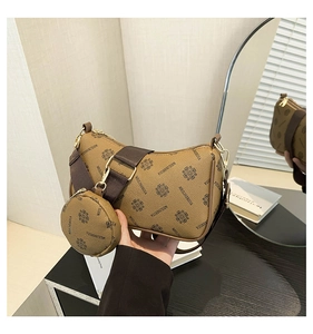Detail of vintage monogram baguette bag set with wide shoulder strap and round coin purse